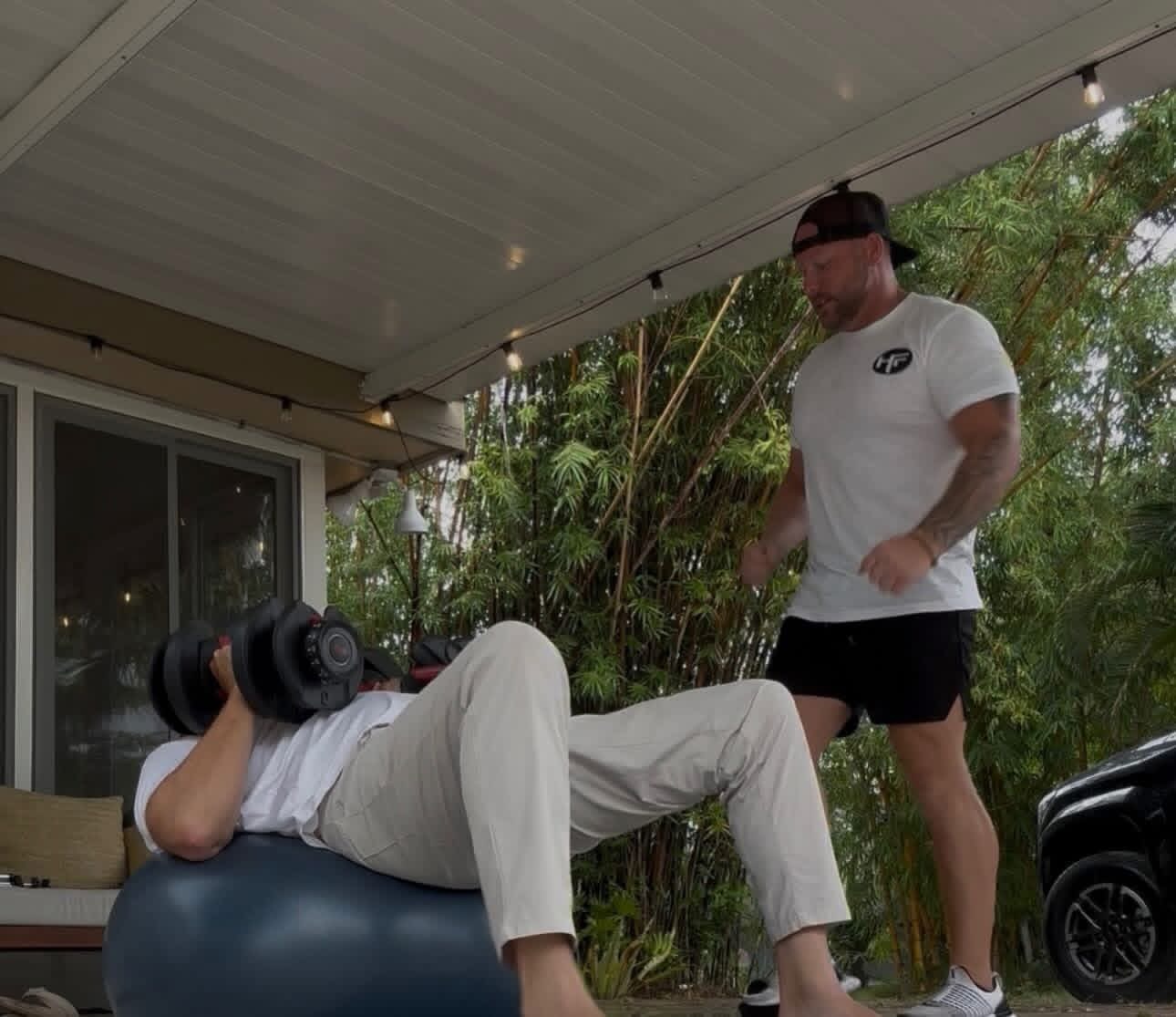 Ryan Hubble coaching a client through a dumbbell exercise during a mobile personal training session