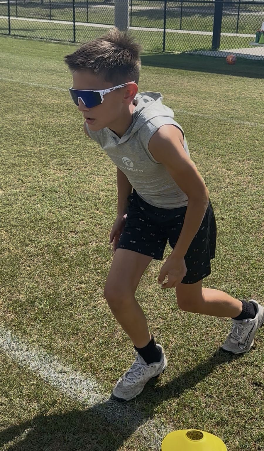 Young Hubb.Fit athlete preparing for an outdoor speed and agility drill