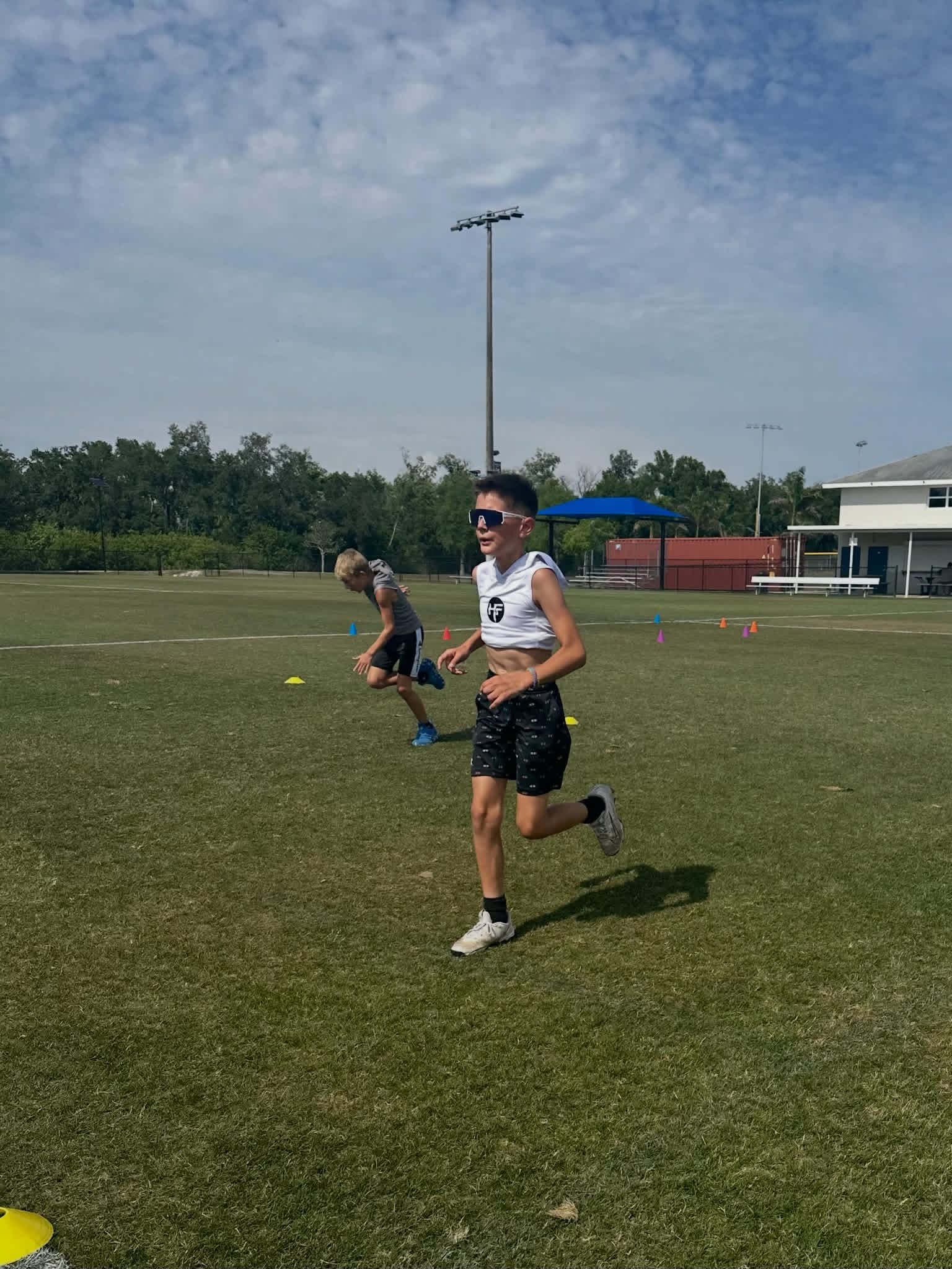 Young Hubb.Fit athlete training speed and running mechanics on a field